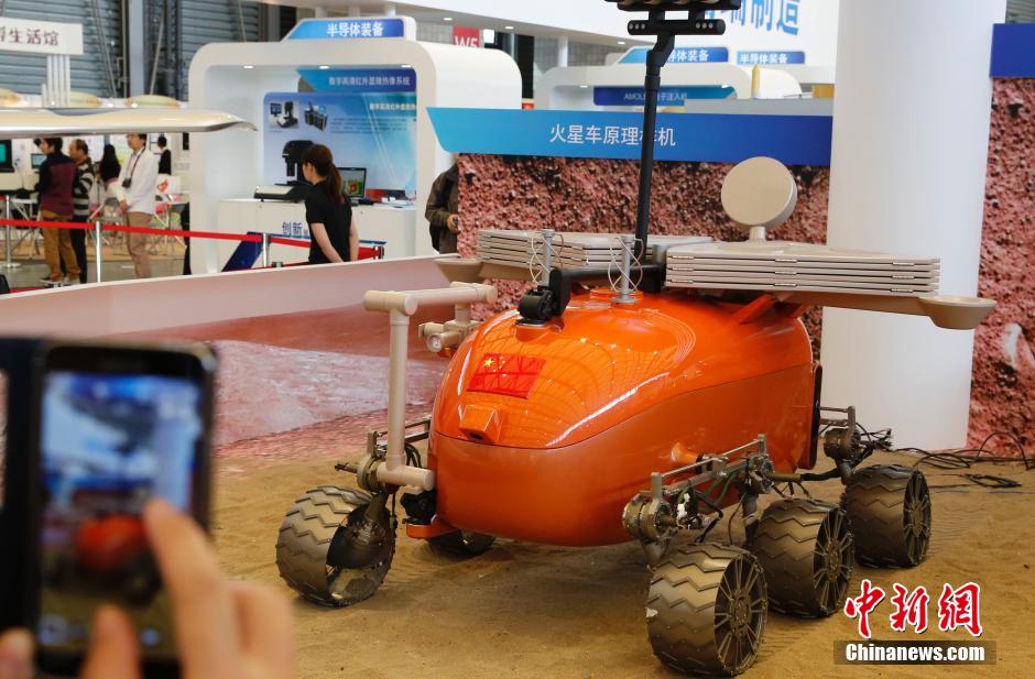 El prototipo del vehículo automatizado Mars Rover (el explorador de Marte) de fabricación China atrae a los visitantes en Shanghai, durante la Feria Internacional Industrial 2014. Sobre la base tecnológica del primer vehículo lunar chino, conocido como "Conejo de Jade", el Instituto de Investigaciones de Ingeniería Aeroespacial de Shanghai, en colaboración con otros institutos extranjeros, llevó a cabo la investigación, desarrollado numerosos prototipos digitales. [Foto/CNS]