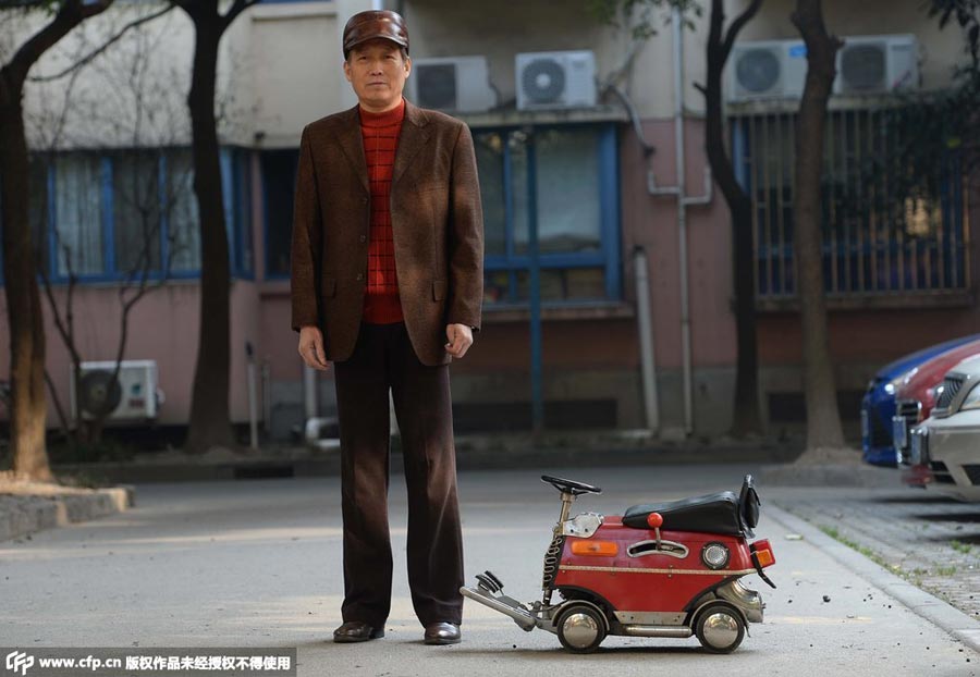 Xu Zhiyun conduce su mini coche fabricado a sí mismo en Shanghai, el 24 de diciembre de 2014. [Foto/CFP]