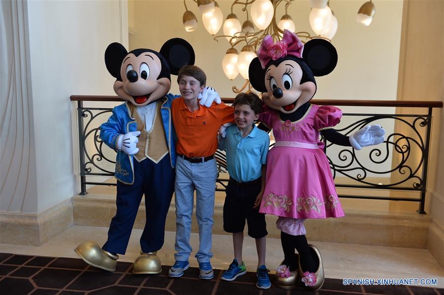 Visitantes posan con empleados vestidos como personajes de Disney en el Shanghai Disneyland Hotel en Shanghai, en el este de China, el 14 de junio de 2016. El Shanghai Disney Resort, el sexto en el mundo, abrirá oficialmente el 16 de junio. (Xinhua/Liu Xiaojing)