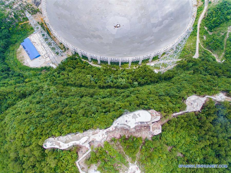 GUIZHOU, junio 21, 2016 (Xinhua) -- Vista del telescopio de apertura sencilla esférica FAST y una plataforma de observación, en el condado de Pingtang, provincia de Guizhou, en el suroeste de China, el 21 de junio de 2016. El Telescopio de Apertura Esférica de 500 metros, o FAST, programado para ser completado en el 2016, se espera que sea el más grande del mundo, superando al Radiotelescopio de Arecibo de Puerto Rico, que tiene 300 metros de diámetro. (Xinhua/Liu Xu)