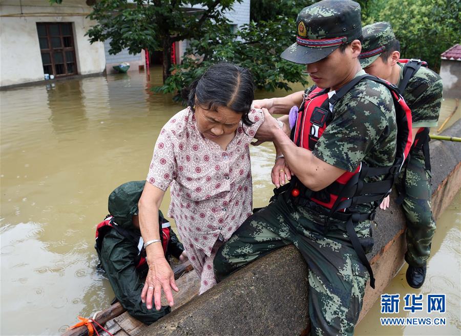 La foto demuestra a soldados rescatando a una mujer atrapada en la inundación en un pueblo de la provincia china de Huangshan. (Xinhua)
