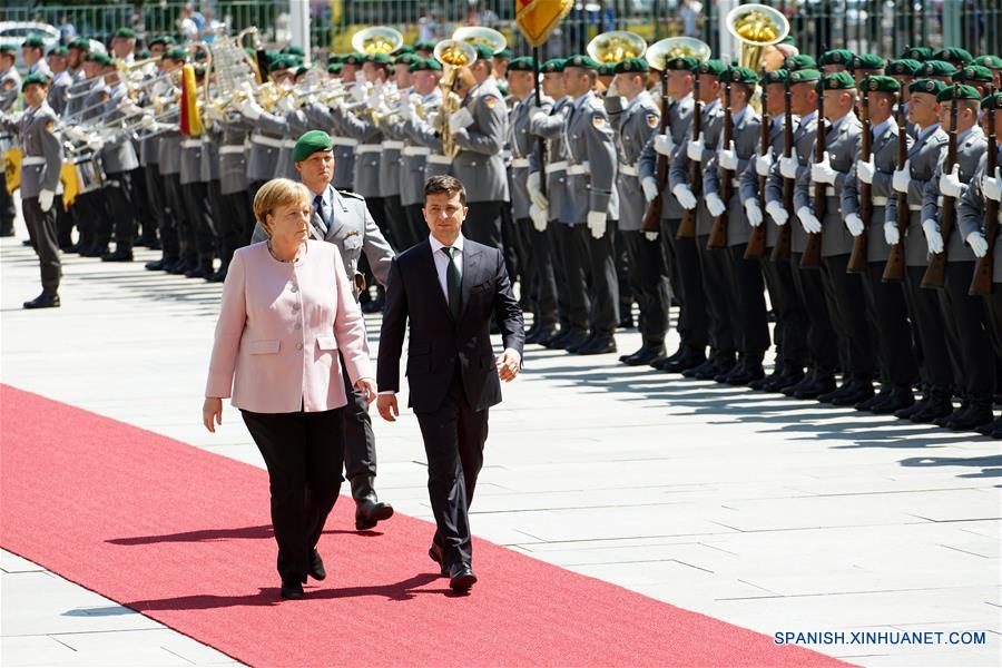 La canciller de Alemania, Angela Merkel (i), y el visitante presidente de Ucrania, Volodymyr Zelensky, pasan revista a una guardia de honor en Berlín, Alemania, el 18 de junio de 2019. (Xinhua/Wang Qing)
