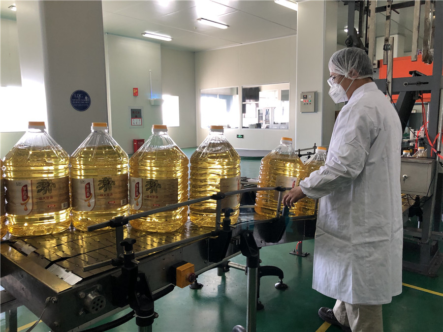 Un empleado de Louis Dreyfus Company, empresa francesa de productos agrícolas, verifica si el aceite de soya cumple con los estándares de almacenamiento, Tianjin, 20 de febrero del 2020. [Foto: Xinhua]