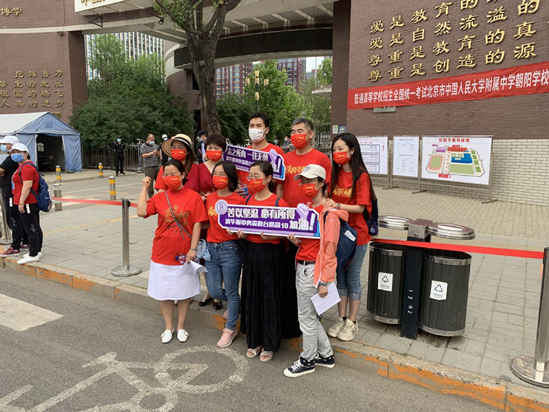 Maestros animan a sus estudiantes que realizarán el Examen Nacional de Ingreso a la Universidad en Chaoyang, Beijing, 7 de junio del 2021. [Foto: Chen Zebing/ China Daily]