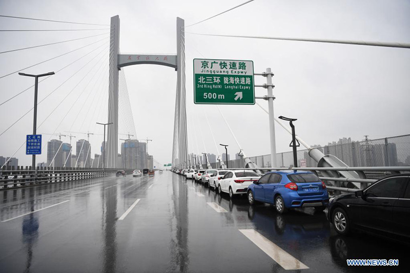 La gente estaciona sus vehículos en un paso elevado en Zhengzhou, capital de la provincia de Henan, en el centro de China, el 22 de agosto de 2021. (Xinhua / Zhang Haoran)