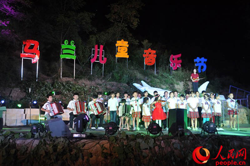 Deng Xiaolan y los niños de la aldea Malan cantan durante un concierto del 2013. (Foto: Pueblo en Línea/ Shen Yaxin)