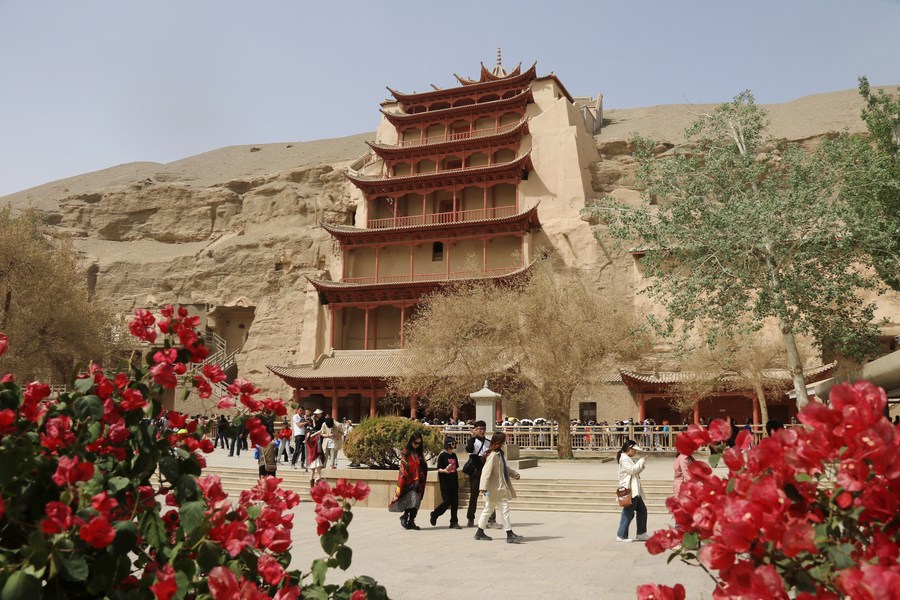 Turistas visitan las grutas de Mogao, en Dunhuang, ciudad de la provincia noroccidental china de Gansu, el 2 de mayo de 2023. (Xinhua/Zhang Xiaoliang)