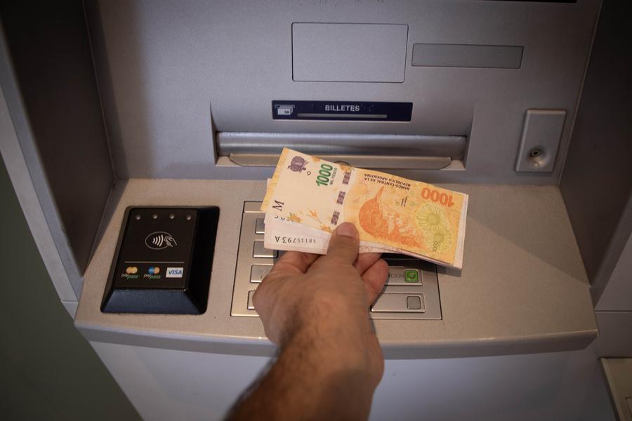 Un hombre retira dinero de una terminal de cajero automático en una sucursal bancaria, en la ciudad de Buenos Aires, capital de Argentina, el 13 de enero de 2024. (Xinhua/Martín Zabala) 