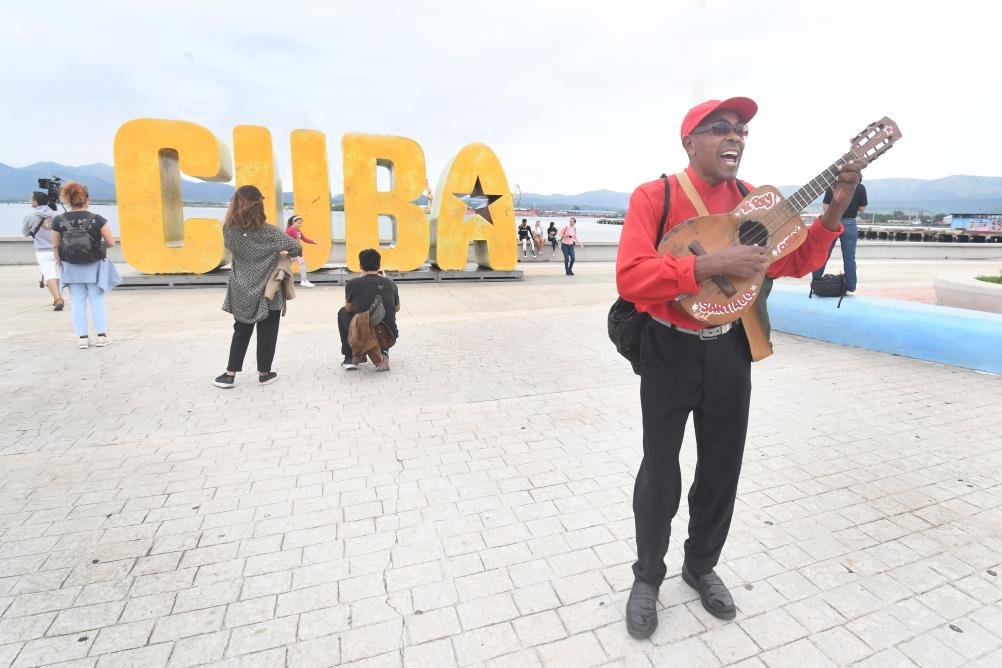 Imagen del 31 de diciembre de 2023 de un músico callejero cantando en un parque, en la ciudad de Santiago de Cuba, en el oriente de Cuba. La industria turística cubana es la segunda fuente de divisas del país. (Xinhua/Joaquín Hernández)