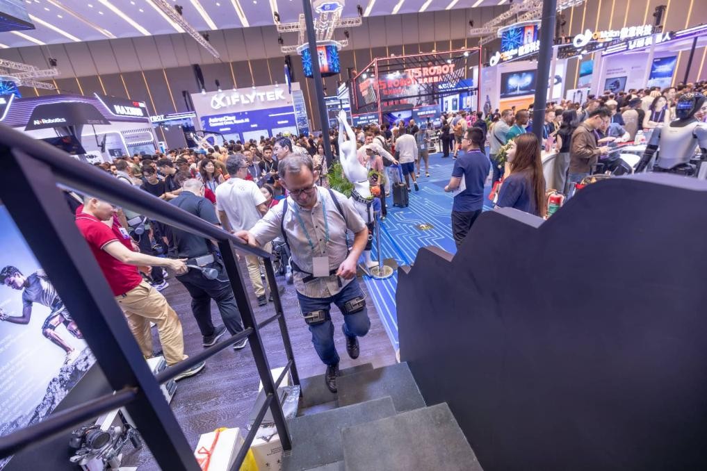 Un comprador extranjero sube escaleras con un robot exoesqueleto en la 139ª edición de la Feria de Importación y Exportación de China, el 17 de abril. (Foto/Fu Haiyan)